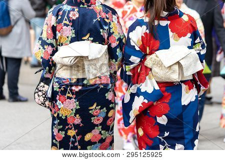 Young Girl Wearing Japanese Kimono Standing In Front Of Sensoji Temple In Tokyo, Japan. Kimono Is A