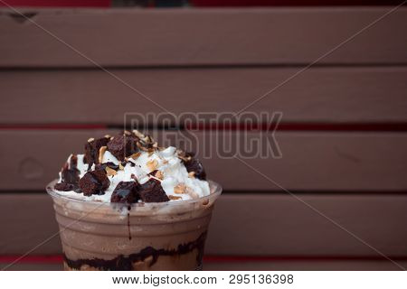 Iced Chocolate Drink Decorated With Whipped Cream And Brownies In A Glass
