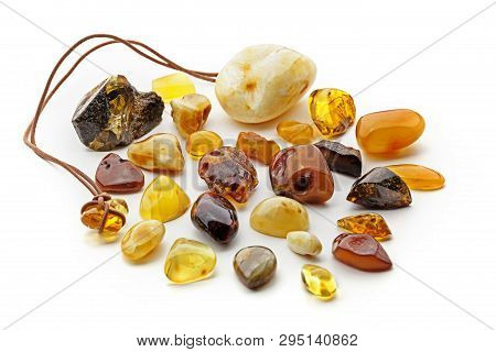Natural Amber. Many Pieces Of Different Colors Of Natural Amber On White Background.