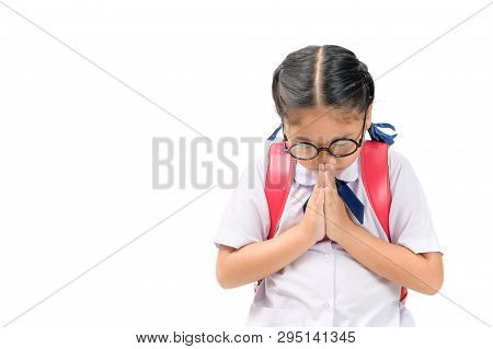 Asian Child In School Uniform And Backpack With Traditional Greeting Of Thailand On White Background