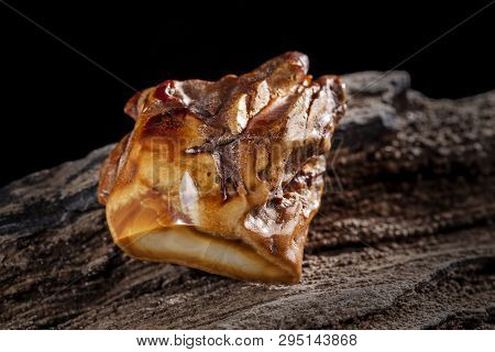 Natural Amber. A Piece Of Brownish Opaque Natural Amber On White Background.