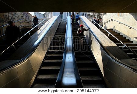 Bucharest, Romania - April 04, 2019: People Go Up And Down The Escalators In The University Passage 