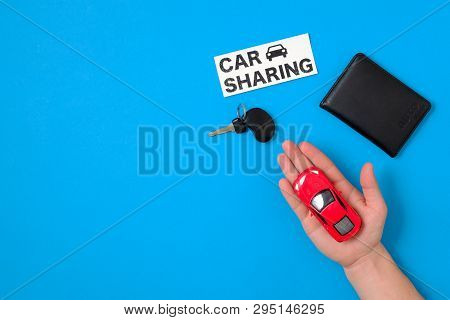 Car Sharing Concept With Toy Car In Human Hand, Auto Drive License, Car Key, Text Sign 