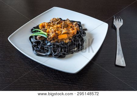 Black Pasta With Cuttlefish Ink. Pasta Of Durum Wheat Semolina With Squid Ink With Beef And Sweet Pe