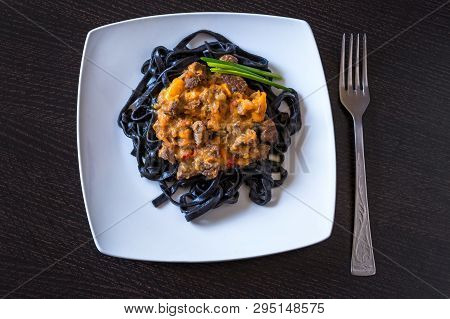 Black Pasta With Cuttlefish Ink. Pasta Of Durum Wheat Semolina With Squid Ink With Beef And Sweet Pe