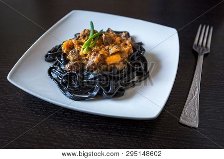 Black Pasta With Cuttlefish Ink. Pasta Of Durum Wheat Semolina With Squid Ink With Beef And Sweet Pe