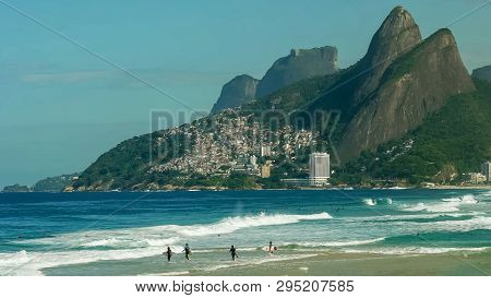 Surfers Paddling Out At Ipanema Beach In Rio De Janeiro