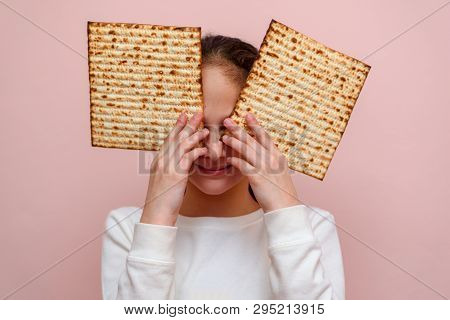 Portrait Of The Cute Teenager Girl Holding Matzah. Jewish Child Having Fun And Eating Matzo Unleaven