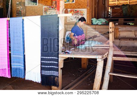 CHIANG RAI, THAILAND- FEBRUARY 2019 : Daily lives of women in a white karen village, a subgroup of the Karen hilltribe in a small village near Chiang Rai, Thailand