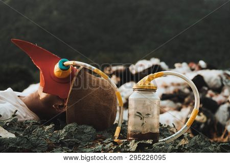 Men Wear A Toxic Mask With A Long Cord Attached To A Glass Bottle With Trees Growing Inside A Glass 