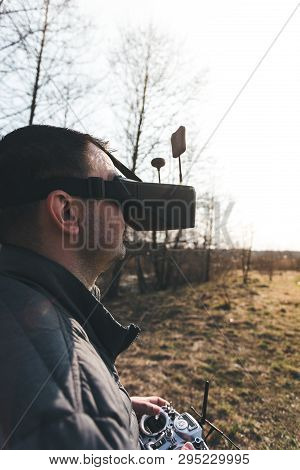 Fpv Drone Pilot In A Virtual Reality Helmet With A Remote Control From A Copter Flies In Aircraft Ou