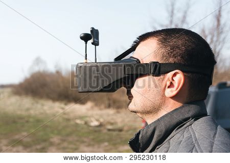 Fpv Drone Pilot In A Virtual Reality Helmet With A Remote Control From A Copter Flies In Aircraft Ou