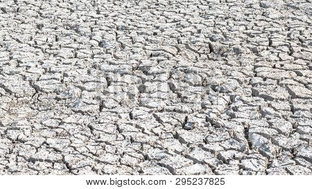 Drought And Desertification Of Dry Waterless Land, Cracked Mud, Arid Ground Soil For Environmental C