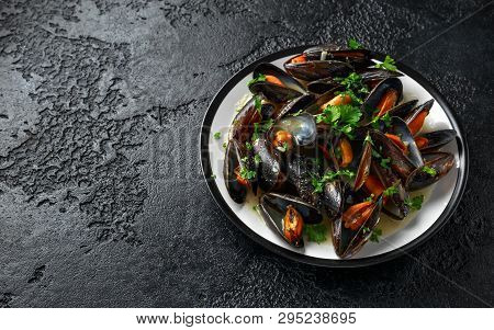Mussels With White Wine, Garlic, Lemon And Herbs In A Plate, Rustick Background. Seafood.