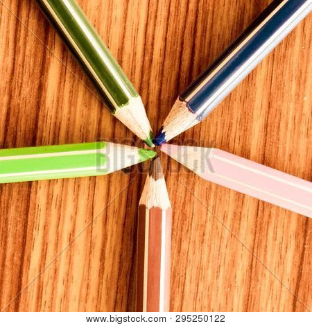 Symbolical Image Central Power Meeting At A Point. Close-up Of A Selection Of Multi Colored Pencils 
