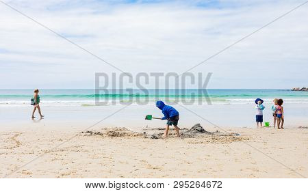 Kids Playing On Fish Hoek Beach On A Cloudy Day