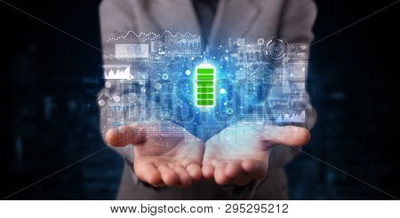 Elegant hand holding battery with full of energy