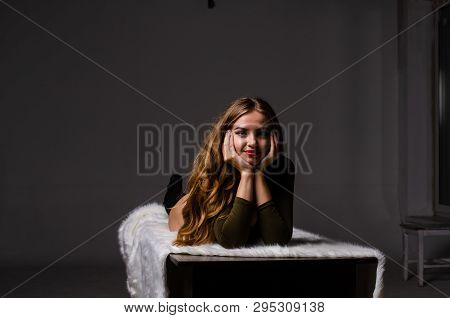 Beautiful Dancer. Girl Model. The Girl Sits In A Hat And Sits On A Table. Girl In A Beautiful Underw