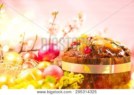 Easter Cake and colorful painted Eggs. Traditional Easter holiday food border design isolated on a white background. Panetone. Spring Holidays delicious glazed cake decorated with fruits