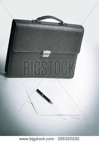 Brown Leather Briefcase Of A Businessman And A Handle In The Wor