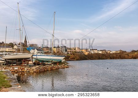 Boats In Clifden Bay Pier With Village In Background