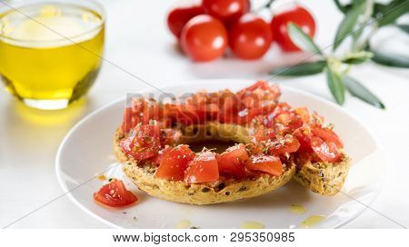 Tipical Summer Dish Of Puglia - Friselle. Classical Frisella With Tomato, Oregano And Olive Oil. Dri
