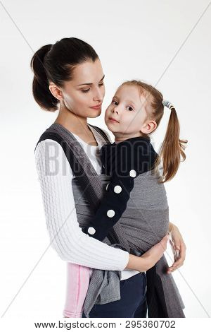 A Toddler Girl In Front Cross Carry Wrap In Woven Baby Carrier