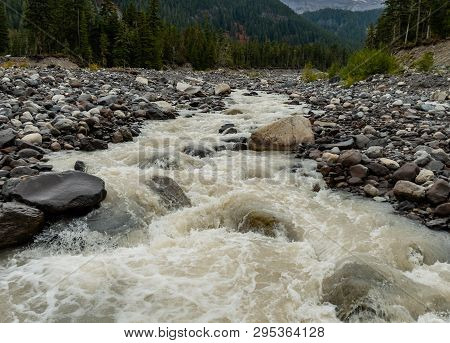 Rushing Water Through Rocky Shores Of Nisqually River At Base Of Mount Rainier