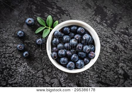 Blueberries In Bowl On Black Concrete Background, Table Top View