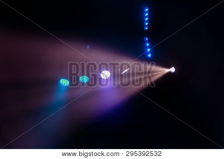 Stage Lights. Several Projectors In The Dark. Multi-colored Light Beams From The Stage Spotlights On