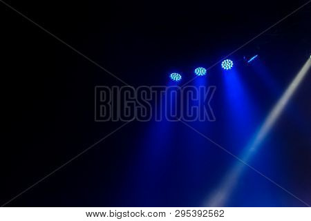 Stage Lights. Several Projectors In The Dark. Multi-colored Light Beams From The Stage Spotlights On