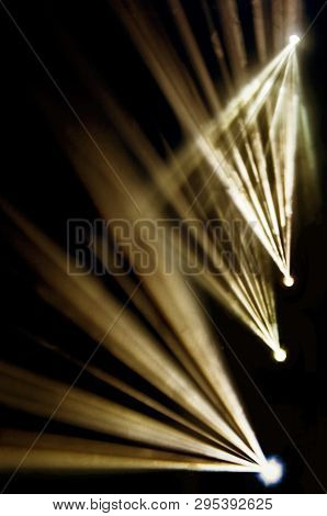 Stage Lights. Several Projectors In The Dark. Multi-colored Light Beams From The Stage Spotlights On