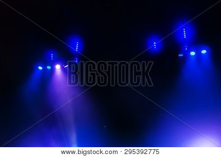 Stage Lights. Several Projectors In The Dark. Multi-colored Light Beams From The Stage Spotlights On