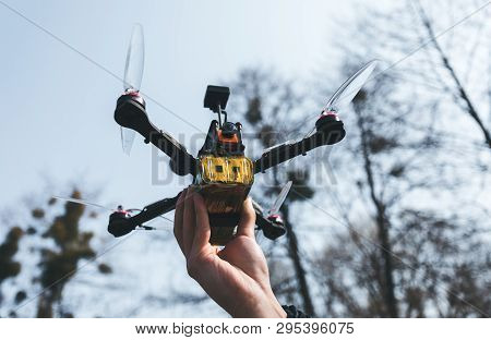 Pilot Racing Drone Holds In His Hand Fpv Copter Before Launching It. A Small High-speed Aircraft Wit