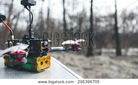 Fpv Drone Lies On The Table. The Pilot Sets Up His Racing Drone Before The Flight.