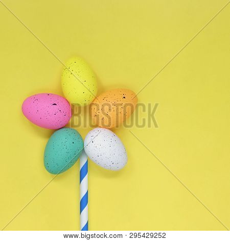Single Flower Made From Colourful Easter Eggs, On A Yellow Background With Copy Space.