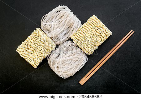 Chinese, Japanese Food Cooking With Rice Vermicelli, Noodles And Sticks On Black Background Top View