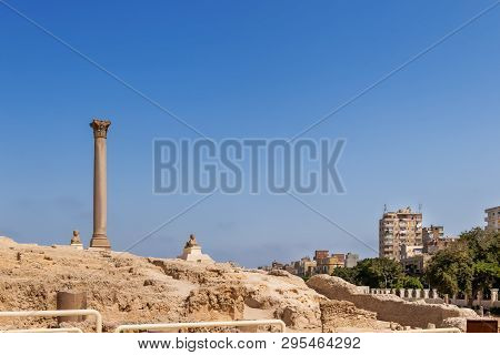 Pompeys Pillar, Roman Triumphal Column, With Two Sphinx Statues Located At The Serapeum Of Alexandri