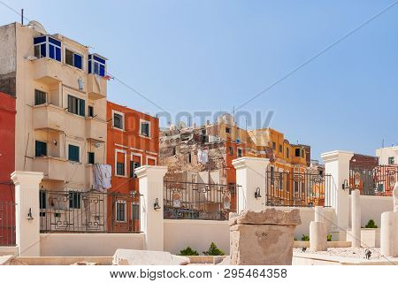 Houses Outside The Fence Of The Serapeum Of Alexandria. Ancient Architectural Landmark In Egypt.