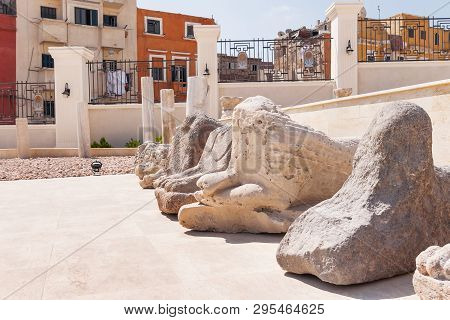 Houses Outside The Fence And Sphinx Statues In The Serapeum Of Alexandria. Ancient Architectural Lan