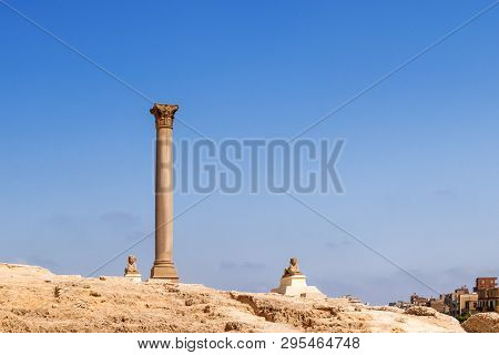 Pompeys Pillar, Roman Triumphal Column, With Two Sphinx Statues Located At The Serapeum Of Alexandri