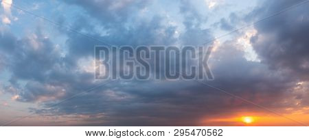 Fantastic Sunset Sky In Colors From Purple To Orange. Sky Background From Dramatic Clouds . Panorama