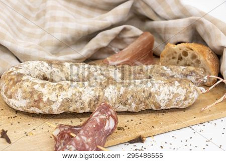 French Charcuterie And Baguette On A Wooden Cutting Board.