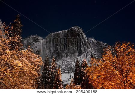 Snowy Yosemite Point Framed By Snow Covered Trees. Yosemite Point And Yosemite Falls At Night.  Clea