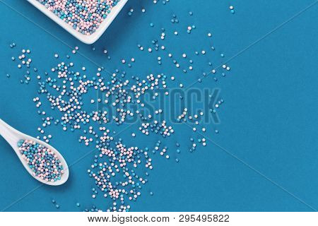 Colorful Nonpareils Cake Candy Sprinkles In Two White Rectangular Bowls And Spoon On Blue Background