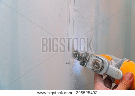 Construction Worker Cutting Gypsum Drywall By Using Electric Cutter Angle Grinder