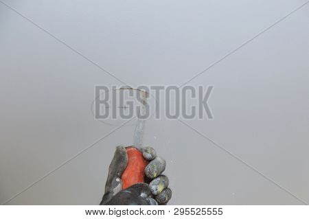 Man Is Cutting Gypsum Board Drywall Panel With Manual Saw Repair Works Renovation In Restoration I