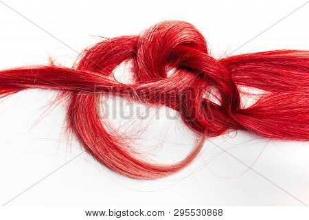 Piece Of Red Hair Tied In A Knot. Damaged Hair