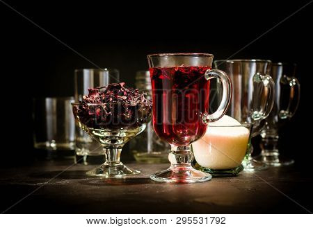Transparent Glass Cup With Hot Red Tea From Hibiscus Or Hibiscus. Glassware And Dry Petals With Suga
