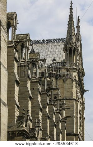 Exhaulted Horizontal View Of Interior Of Notre Dame Of Paris, France In Golden Lights On Ancient Sto